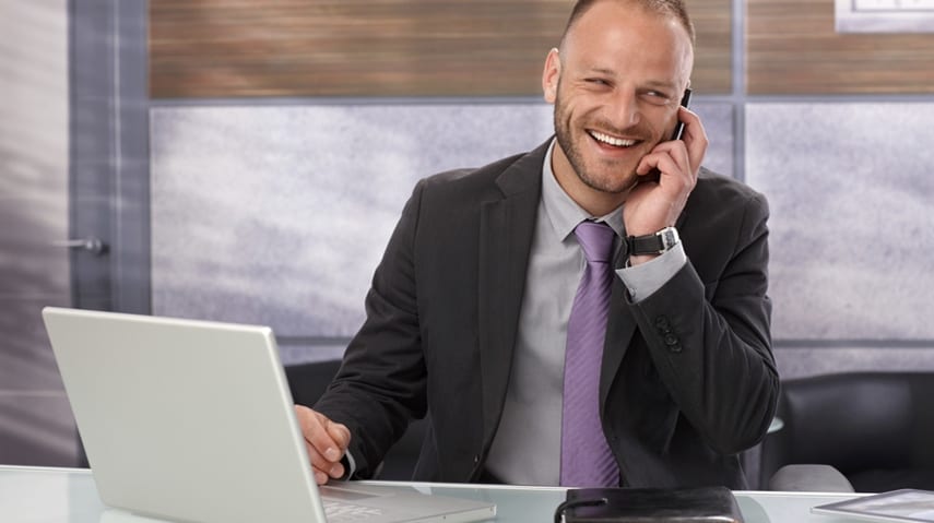 realtor-on-phone-with-contact-book-and-laptop